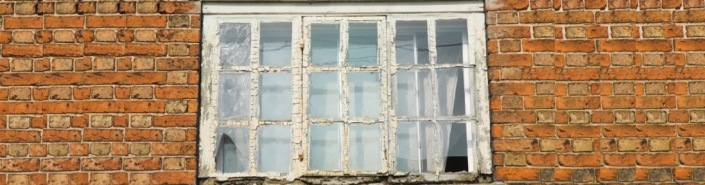 Old flaky timber window with Georgian bars